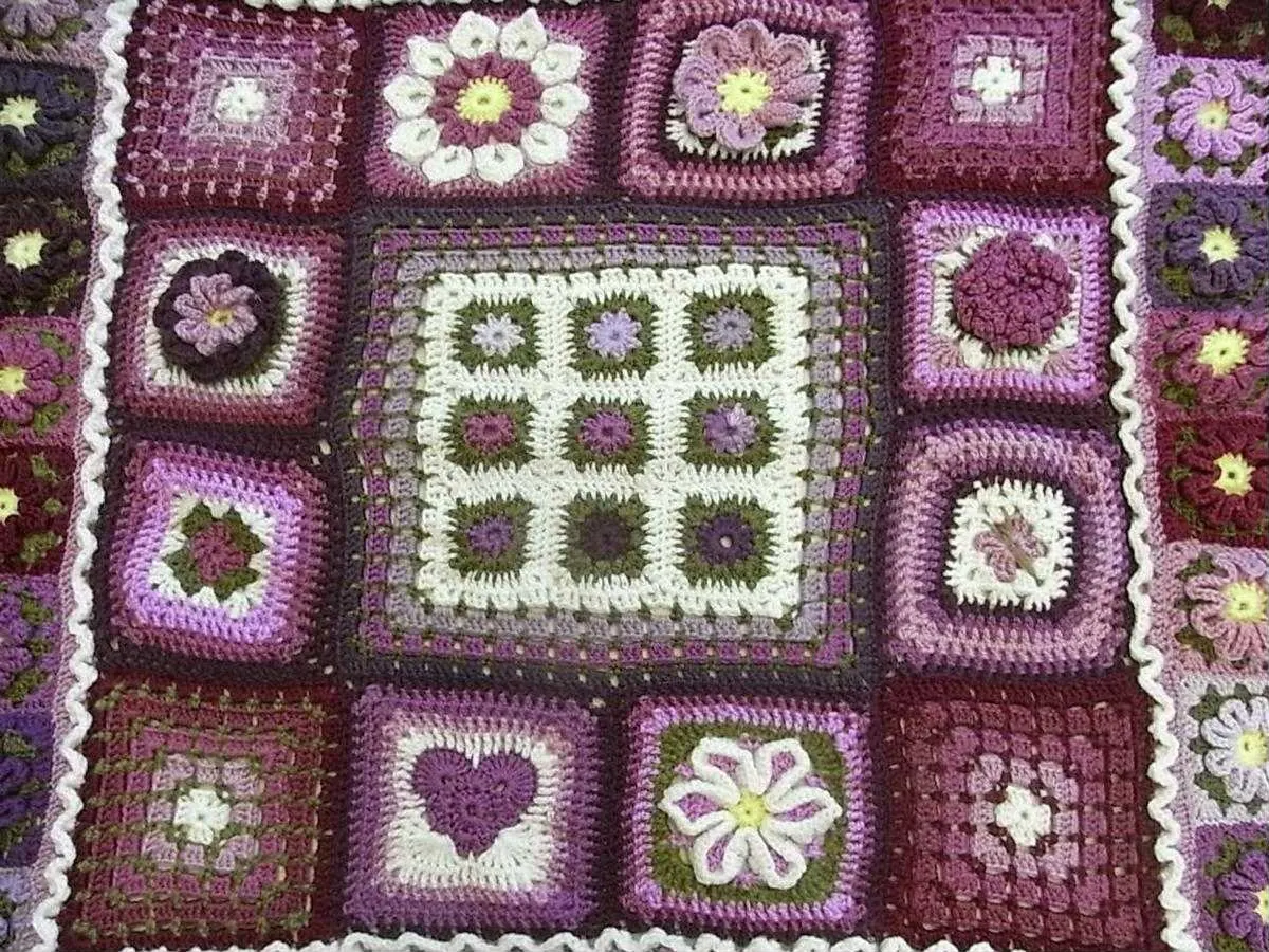 A crocheted blanket of purple and white granny squares
